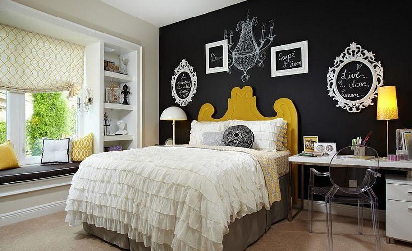 Empty picture frames and chalkboard paint create a vibrat accent wall in the bedroom
