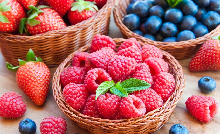 Close up of ripe fresh berries in wooden basket