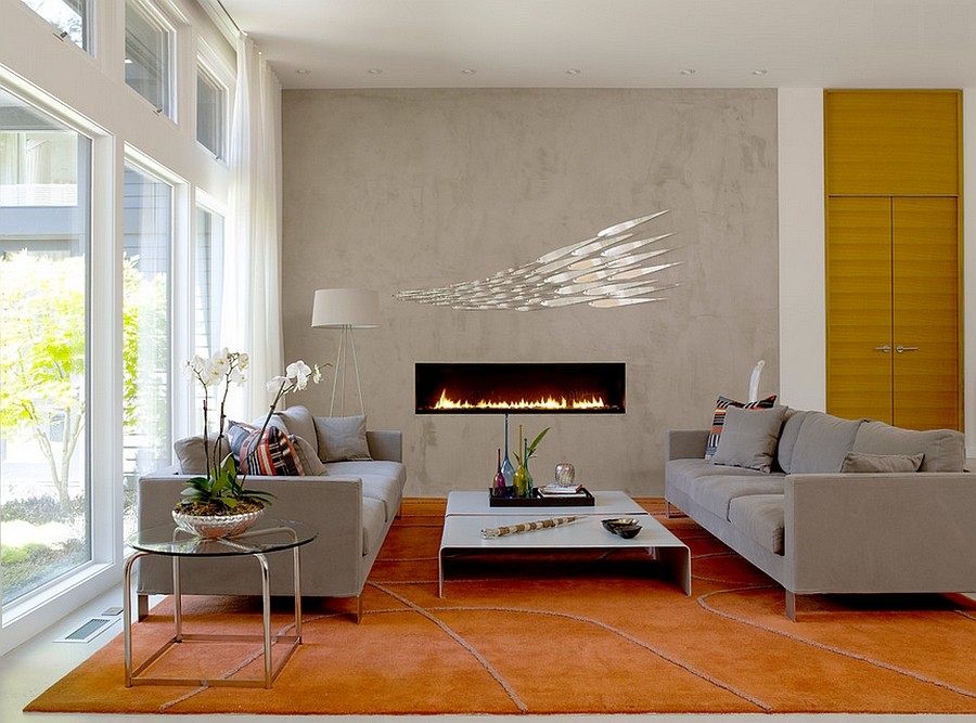 Sleek contemporary fireplace and concerete wall become the focal point in the room